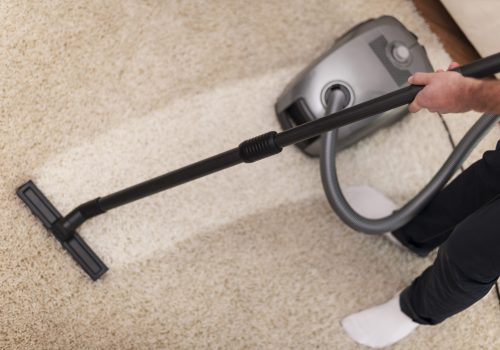 close up vacuuming carpet scaled