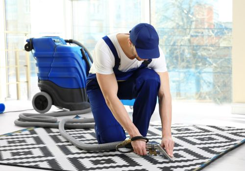 dry cleaner s employee removing dirt from carpet flat scaled
